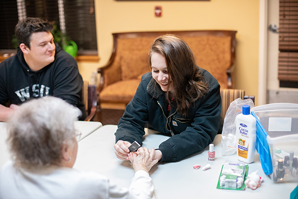 student volunteers at local senior center